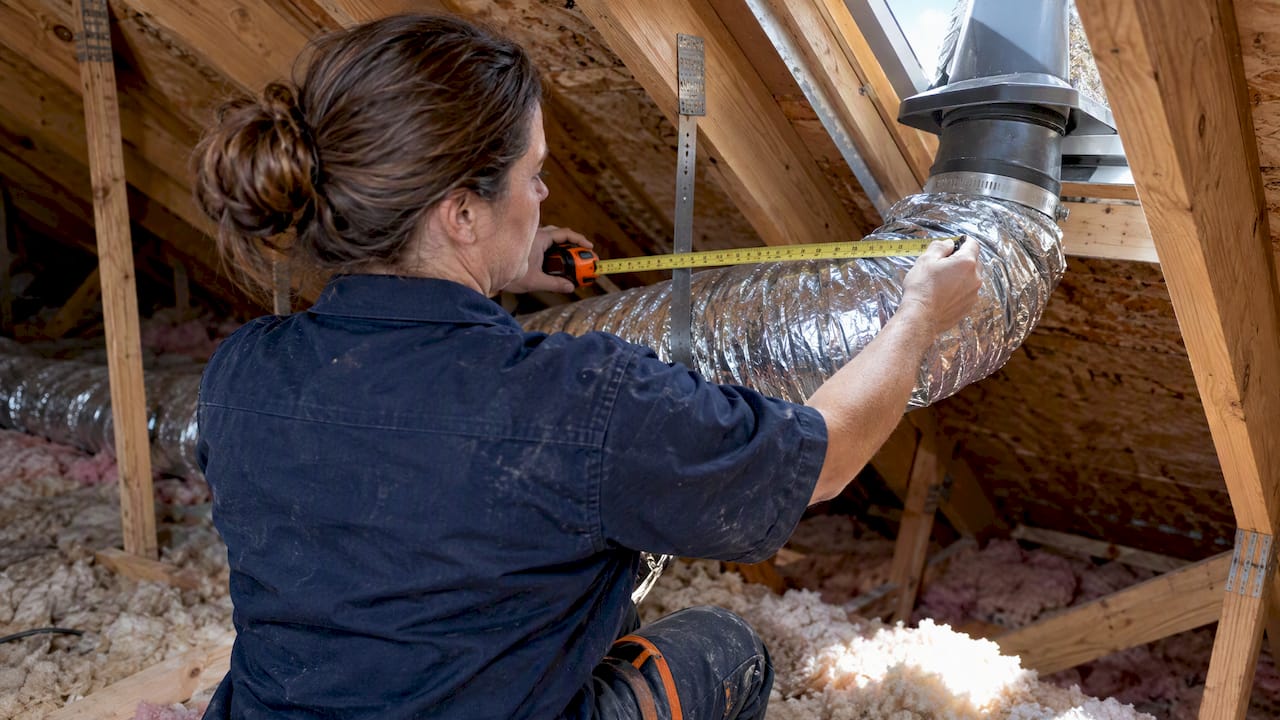 Contractor checking bathroom exhaust ductwork